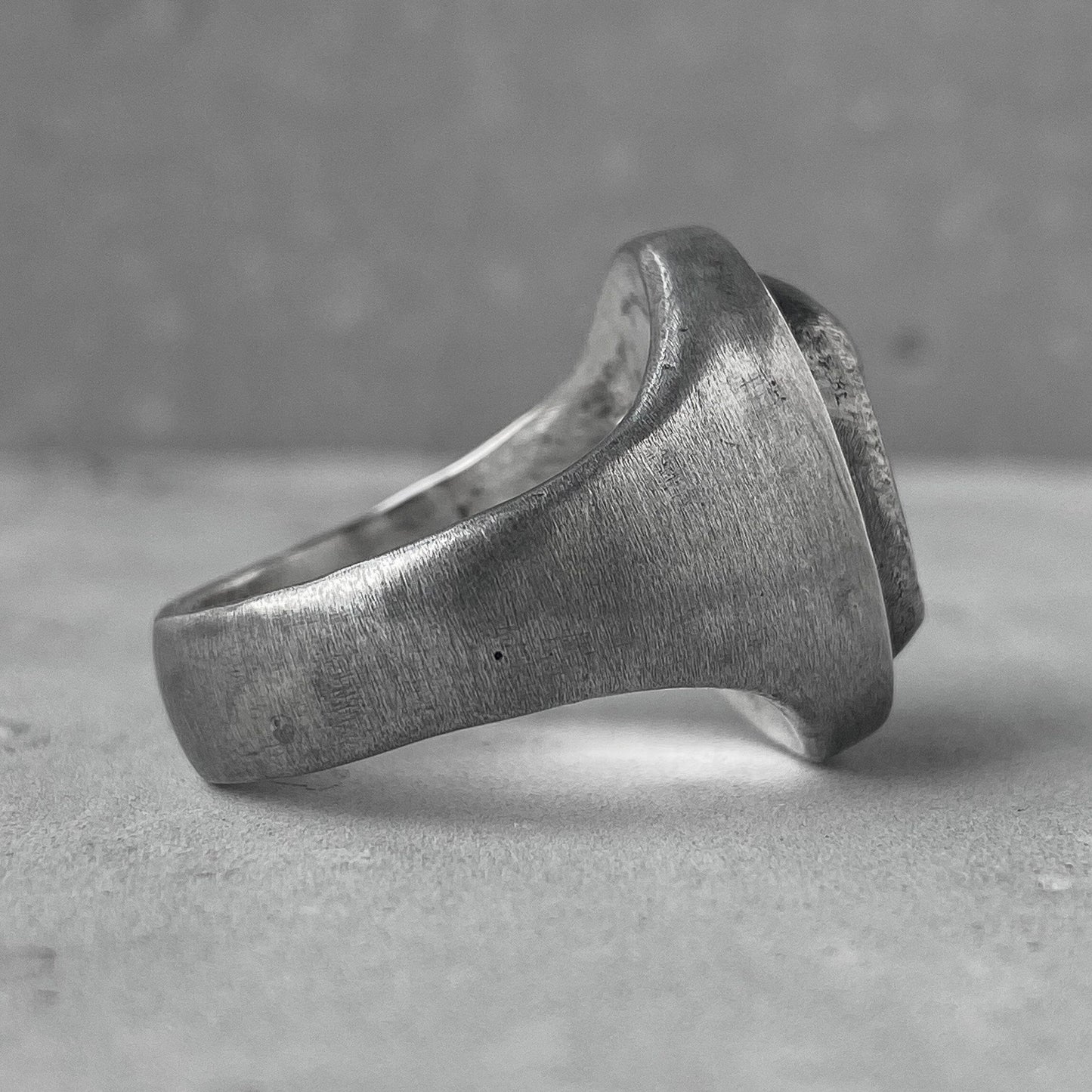 Mask ring-oval signet ring with a matte texture and a silver carved mask on top Unusual rings Project50g 